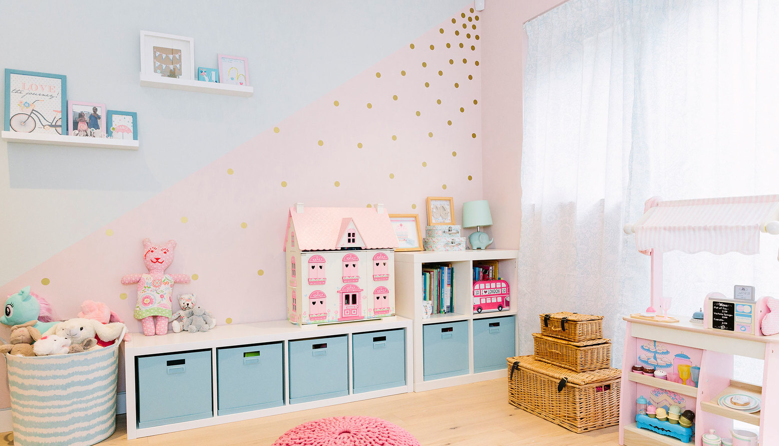 Baby pink and pale turquoise children's bedroom with plenty of storage and fun 