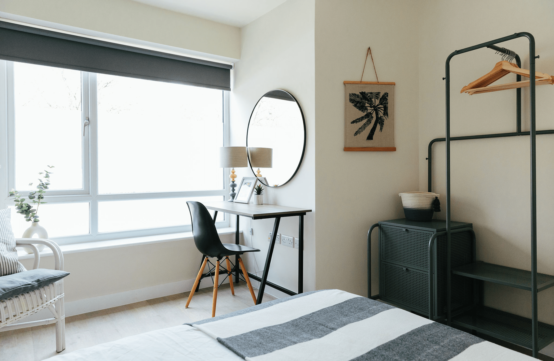 Bed with a desk and clothing rails