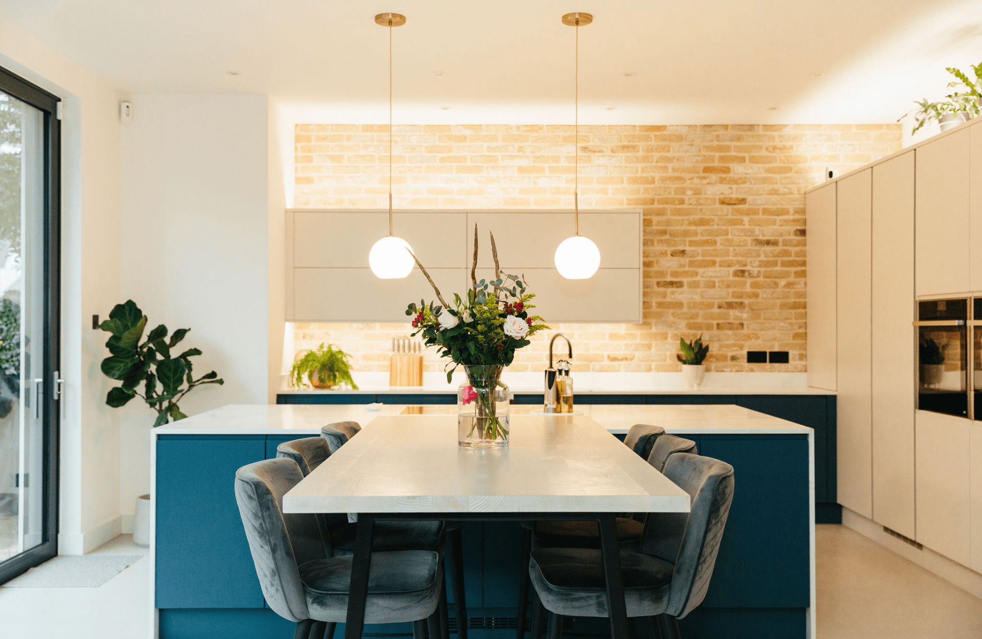 Kitchen and dining area with exposed brick wall